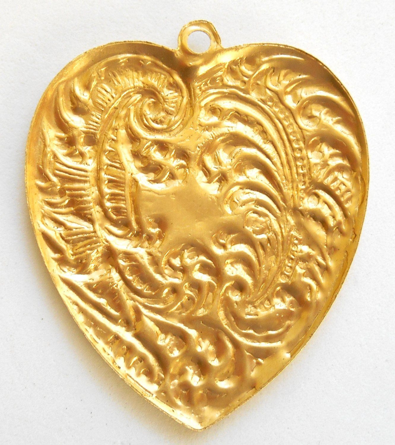 https://www.gloriousglassbeads.com/cdn/shop/products/supplies-one-ornate-victorian-raw-brass-heart-pendant-with-feathers-and-fronds-brass-stamping-53-x-45mm-made-in-the-usa-c9401-3.jpeg?v=1579993811